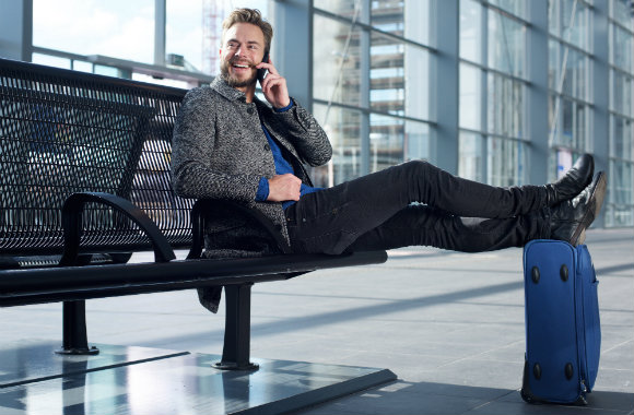 man talking on phone at the airport